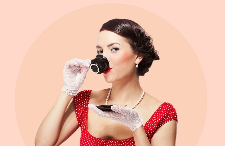 mytinderology-woman-holding-cup-of-tea-red-polka-dress